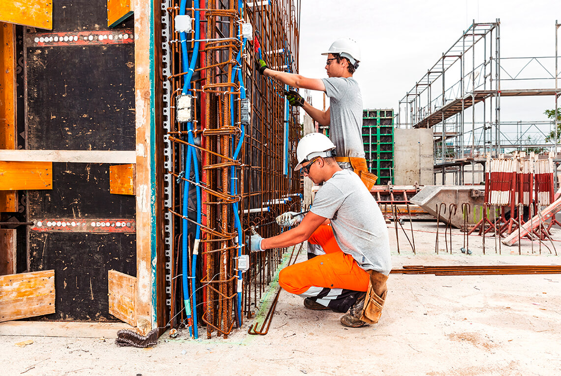 Workers wearing helmets on a safe building site